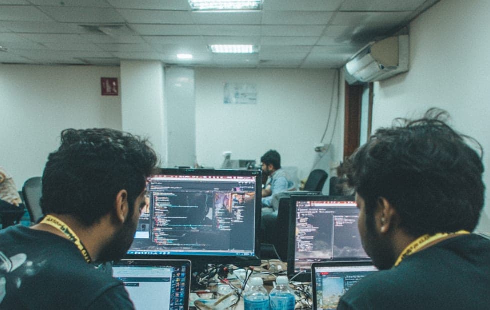 Cybersecurity engineers reviewing a security workflow together.